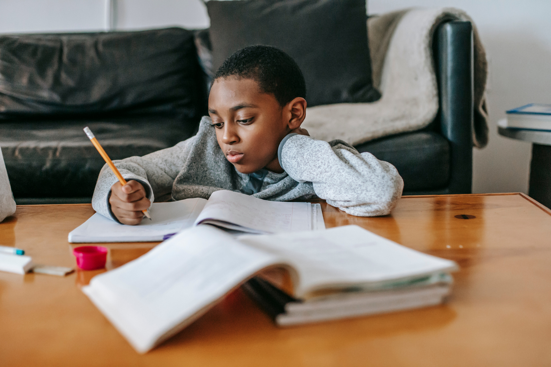 Pensive black boy doing homework